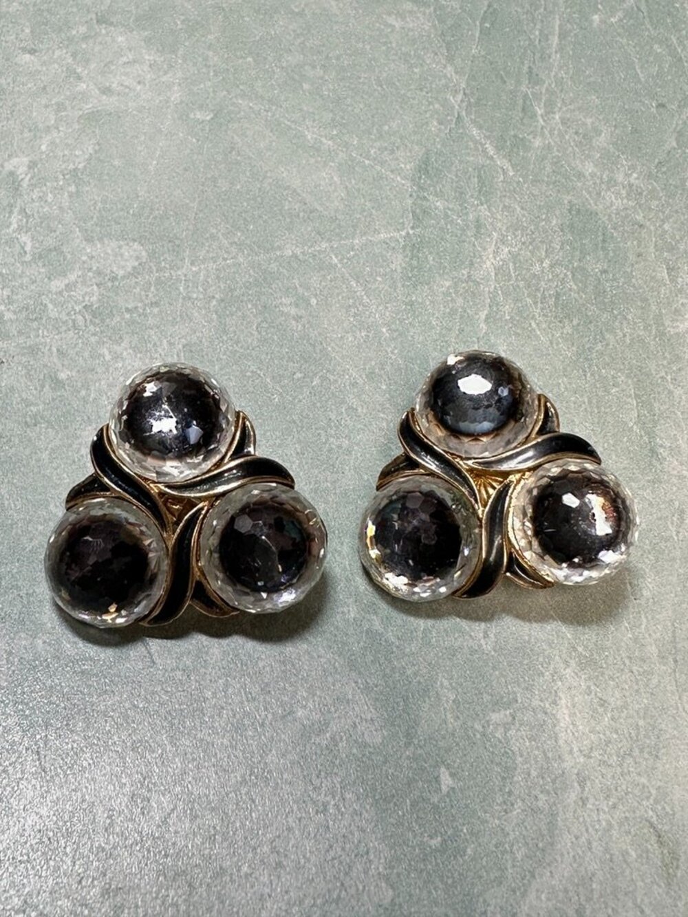 Vintage Vendome gold tone clip on earrings with black and gray round stones